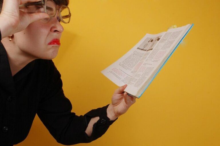 spanish tutor checking a book